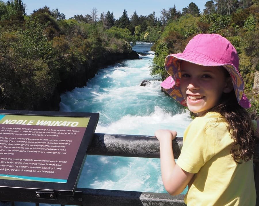 Cute girl taking picture in Huka Falls