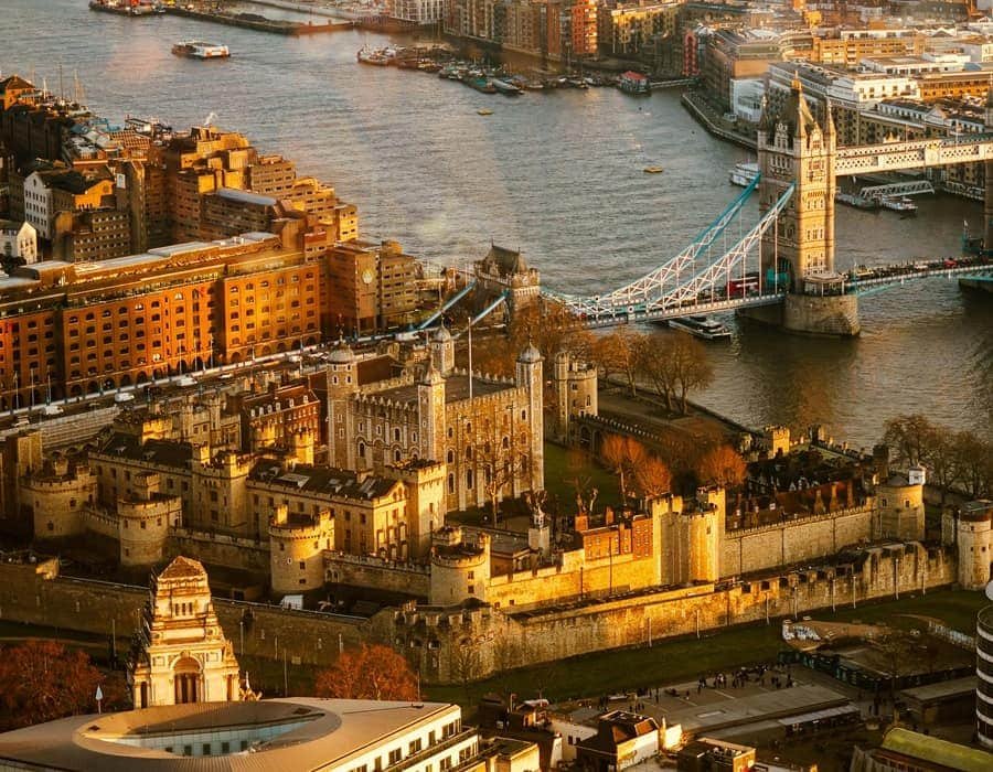 Aerial sunset view of the Tower of London and Tower Bridge on the River Thames