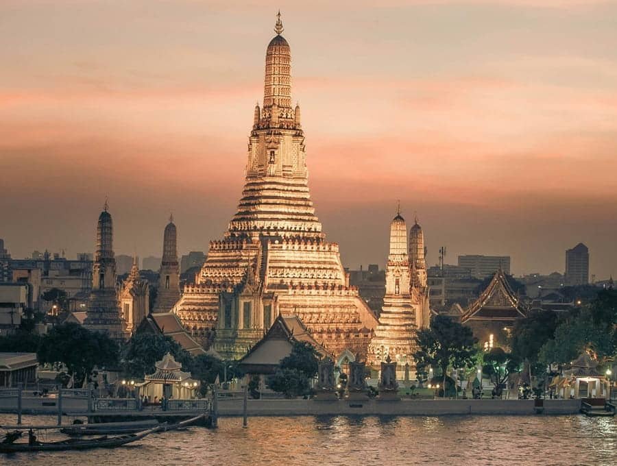 Wat Arun temple in Bangkok by riverside at sunset