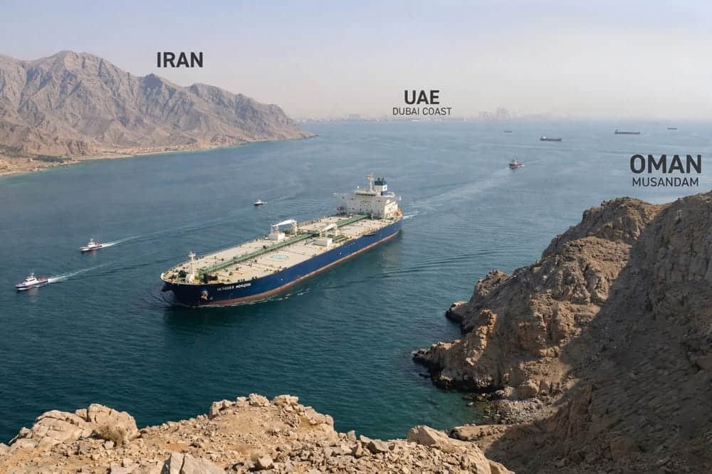 Oil tanker passing through the Strait of Hormuz between Iran and Oman narrow waterway