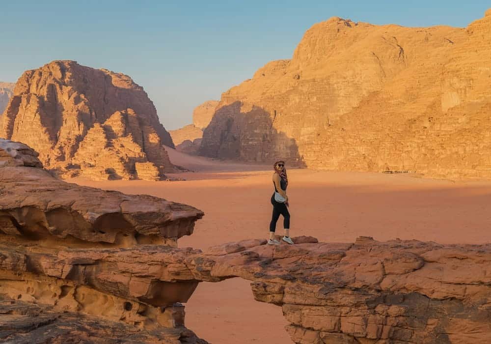 A Woman Standing on a Rock in Wadi Rum